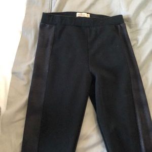 Black leggings with a leather strip on the side.